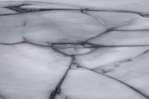 photograph of melting ice on a lake